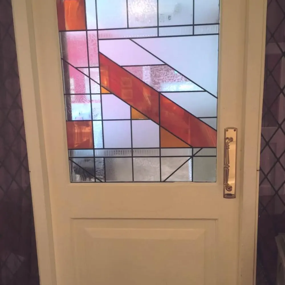 White door fitted with a decorative coloured glass panel